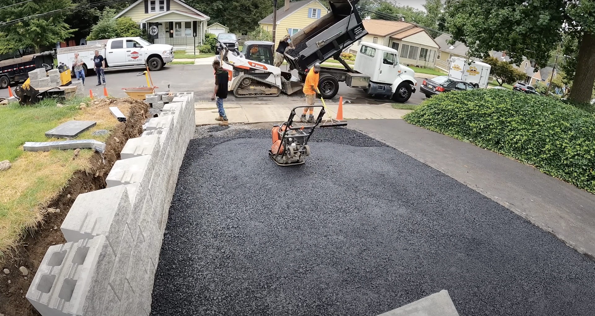 Professional driveway paving and surface preparation services Asphalt driveway installation and compaction work