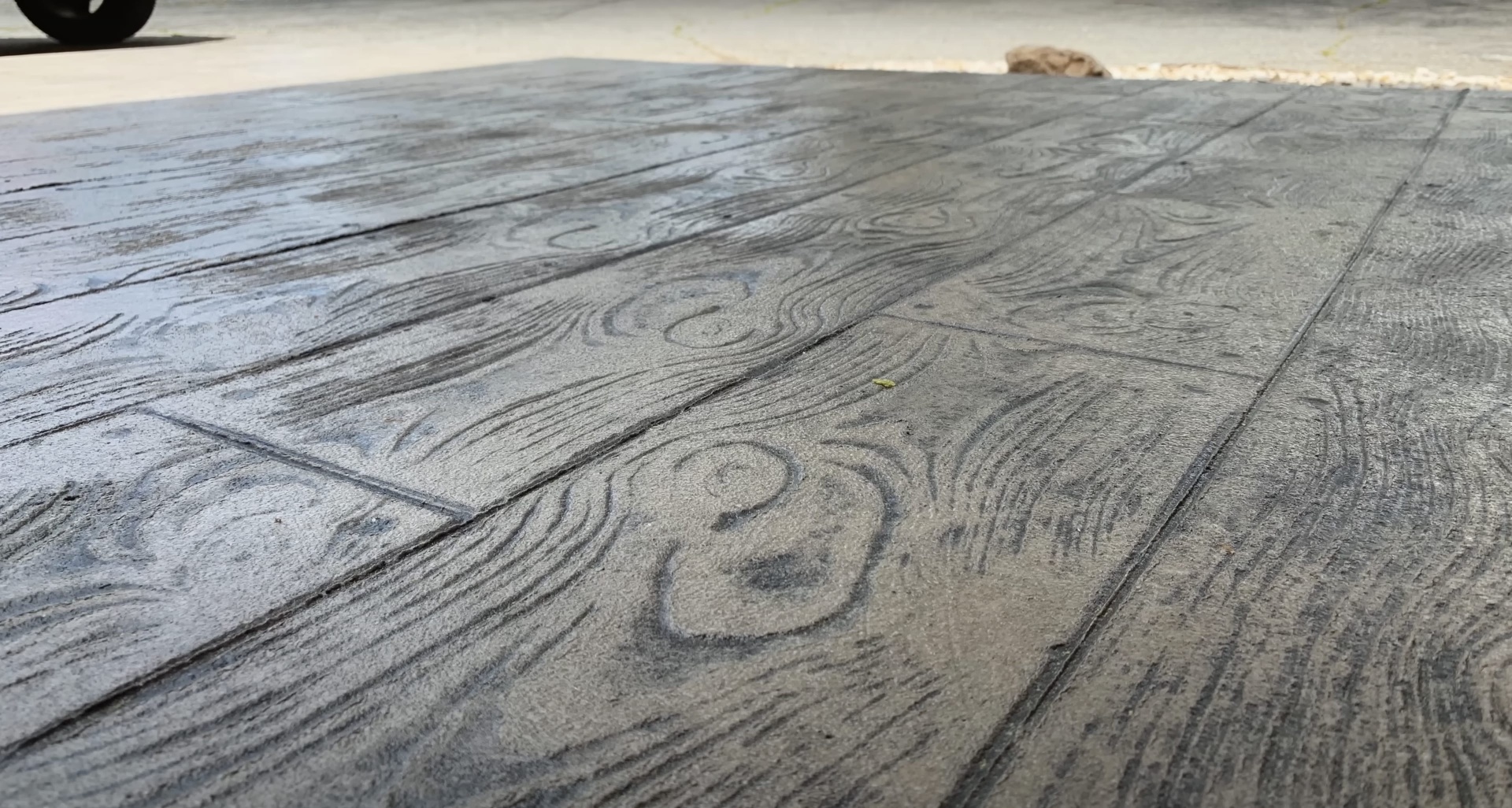 Professional concrete finishing with stamped wood grain pattern Close-up of stamped concrete with wood grain texture pattern
