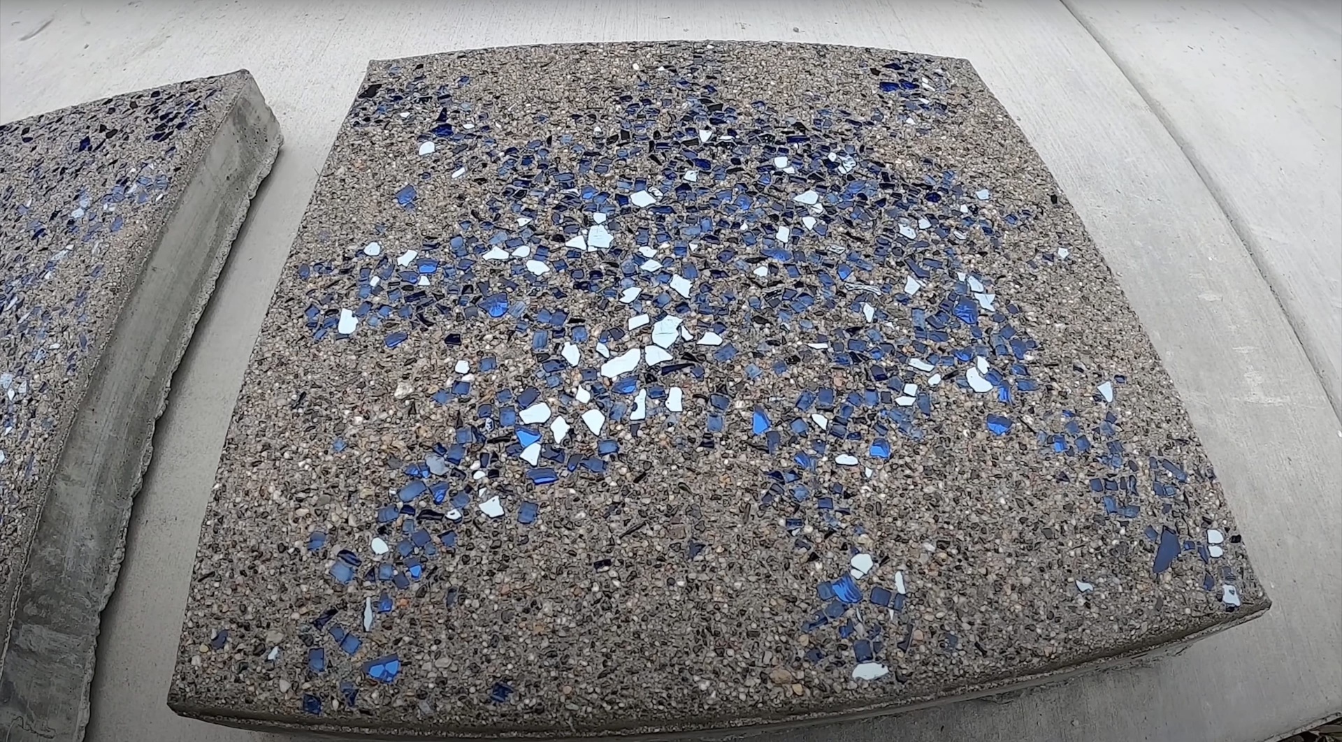 Custom decorative concrete with colored glass aggregate design Decorative concrete with blue and white glass aggregate finish