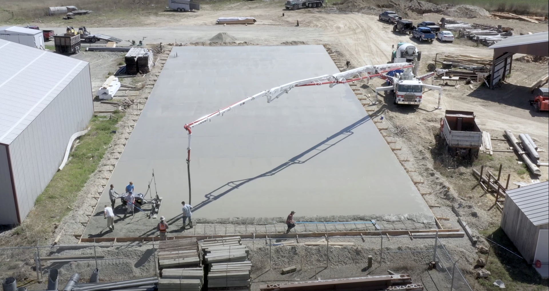 Commercial concrete services with professional equipment and crew Large commercial concrete slab pour with boom pump