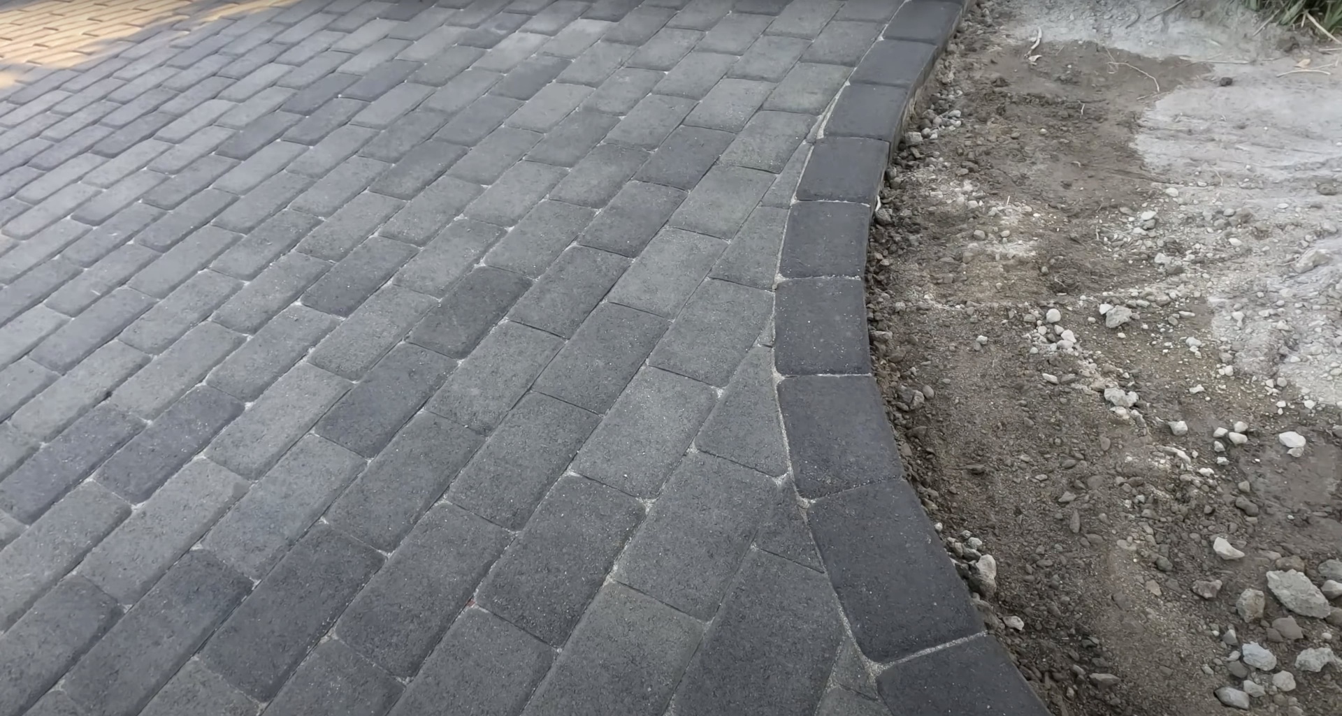 Professional concrete paver and patio construction services Concrete paver installation with herringbone pattern