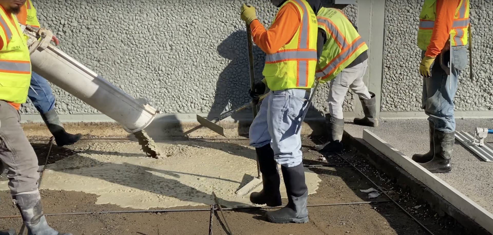 Expert concrete construction team at work Professional concrete workers pouring and finishing concrete